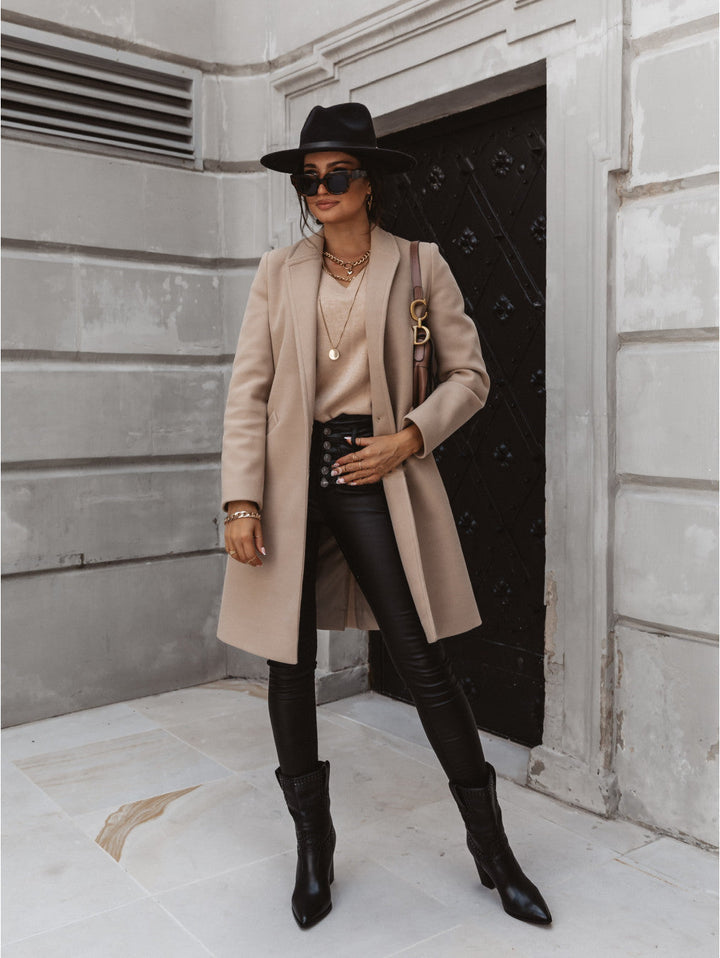Elegant women's double-breasted long trench coat in classic beige for fall fashion.