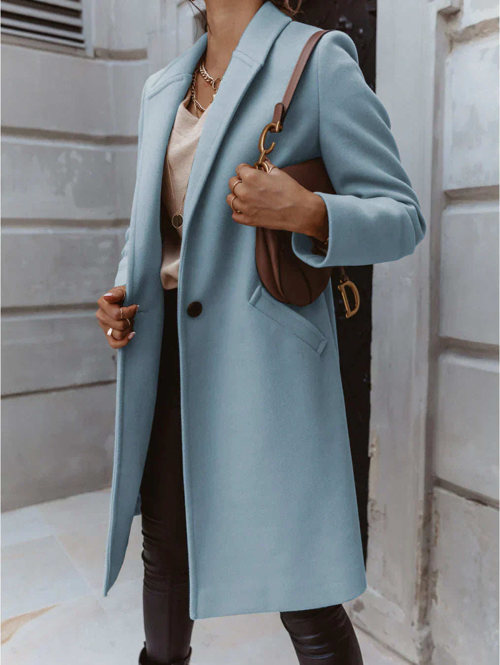 Full-length view of a women's long trench coat, double-breasted design, ideal for fall.