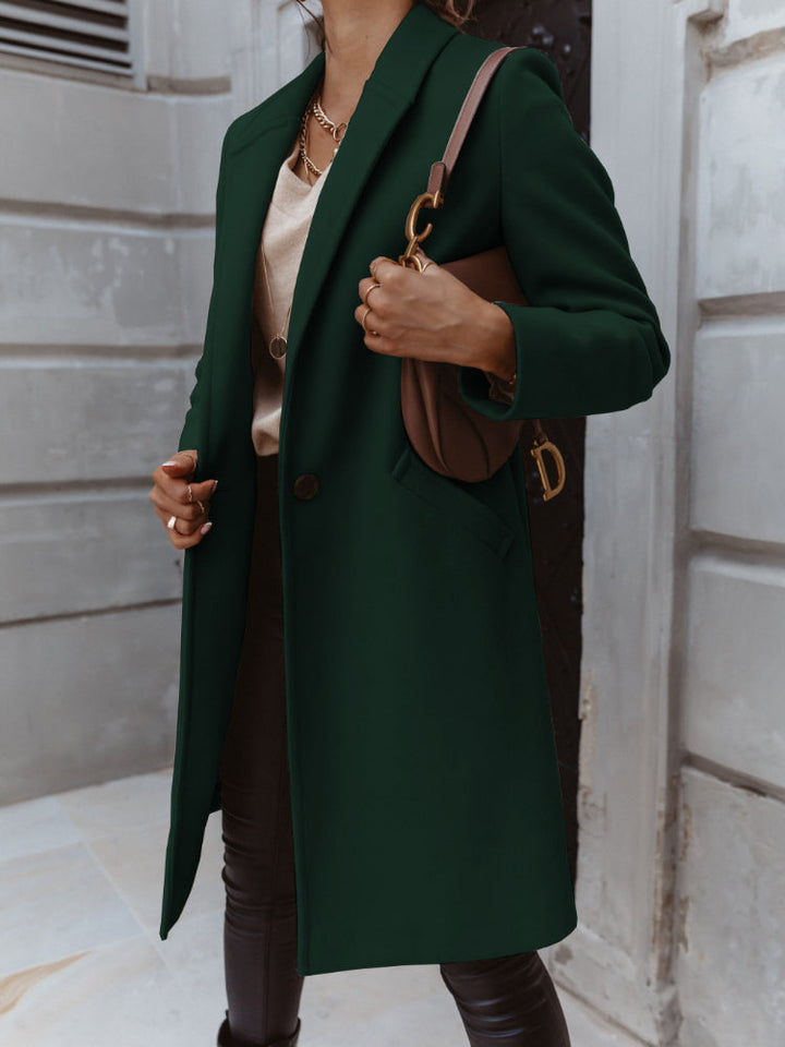 Beige double-breasted long trench coat for women, a timeless and elegant outerwear piece.