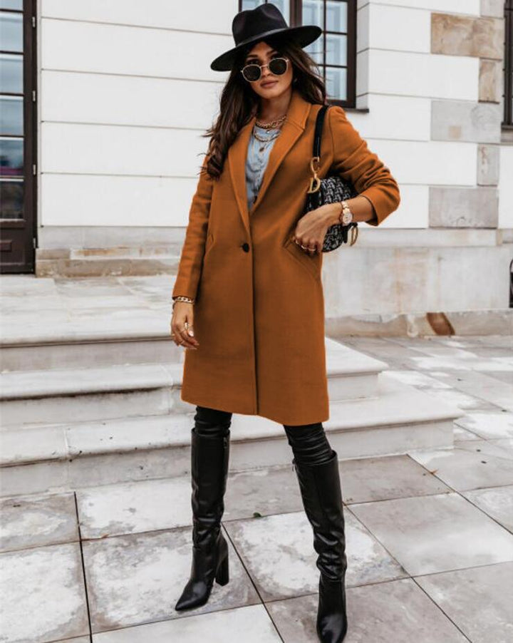 Designer women's long trench coat with double-breasted front, offering elegant fall fashion.