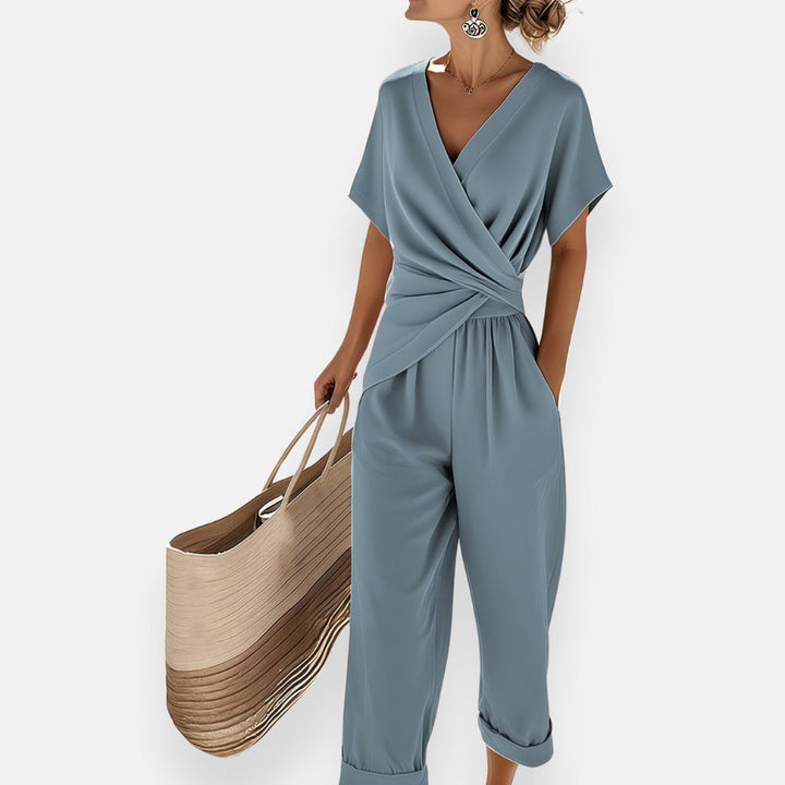 Elegant women's draped jumpsuit with a chic bow detail, perfect for evening wear & special occasions. Modern one-piece.