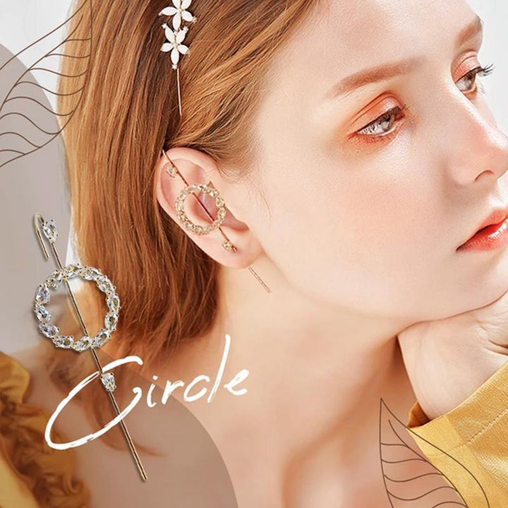 Fashionable women's ear crawler earring, designed to elegantly climb the ear with sparkling rhinestones. White background.
