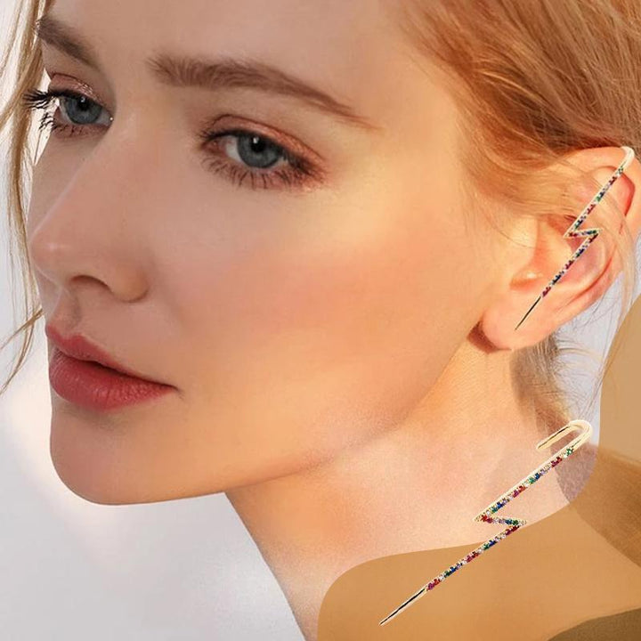 Pair of elegant women's ear wrap crawler earrings, sparkling rhinestones, hypoallergenic for comfort. Flat lay.