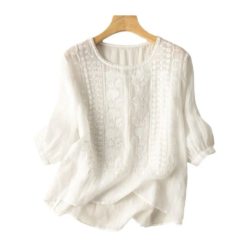 Elegant women's embroidered puff sleeve blouse with floral details, a chic high-low hem & round neck for spring/summer.