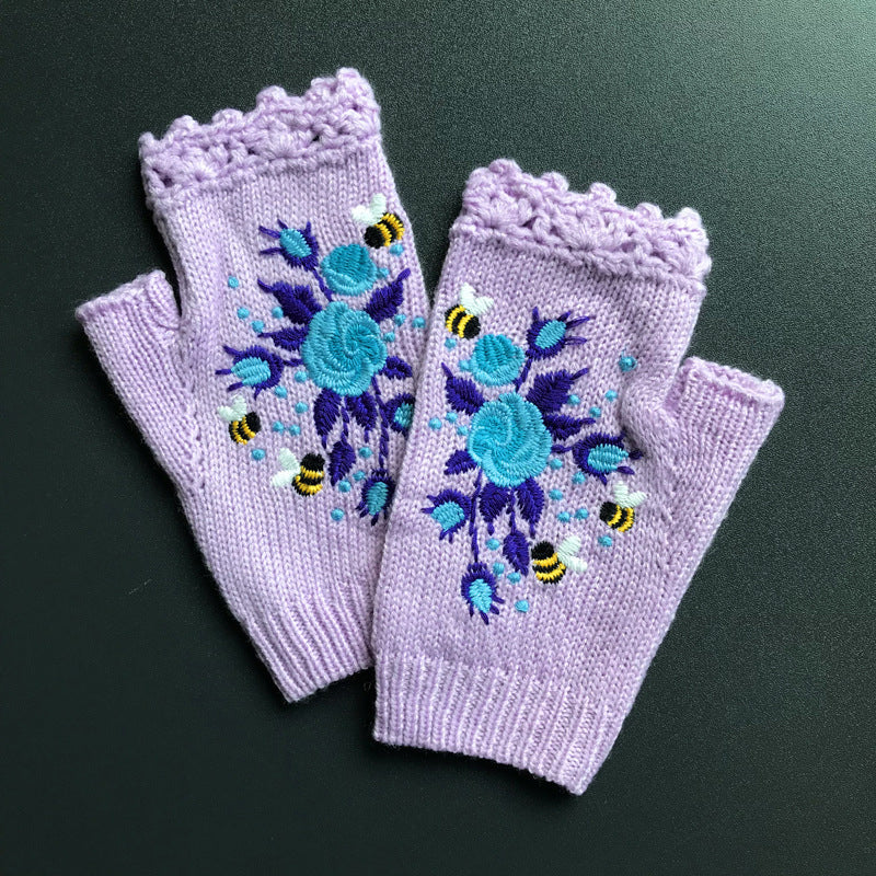 Front view of women's black embroidered winter gloves, showcasing the elegant and festive design.