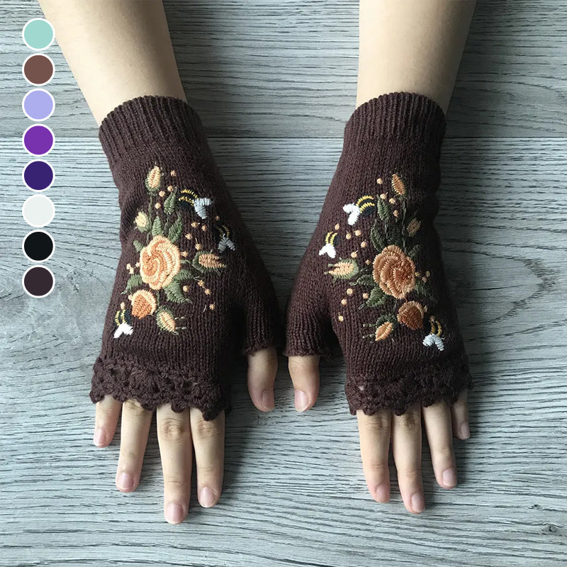 Close-up of women's black embroidered winter glove, intricate multi-color floral stitching, soft acrylic fabric.