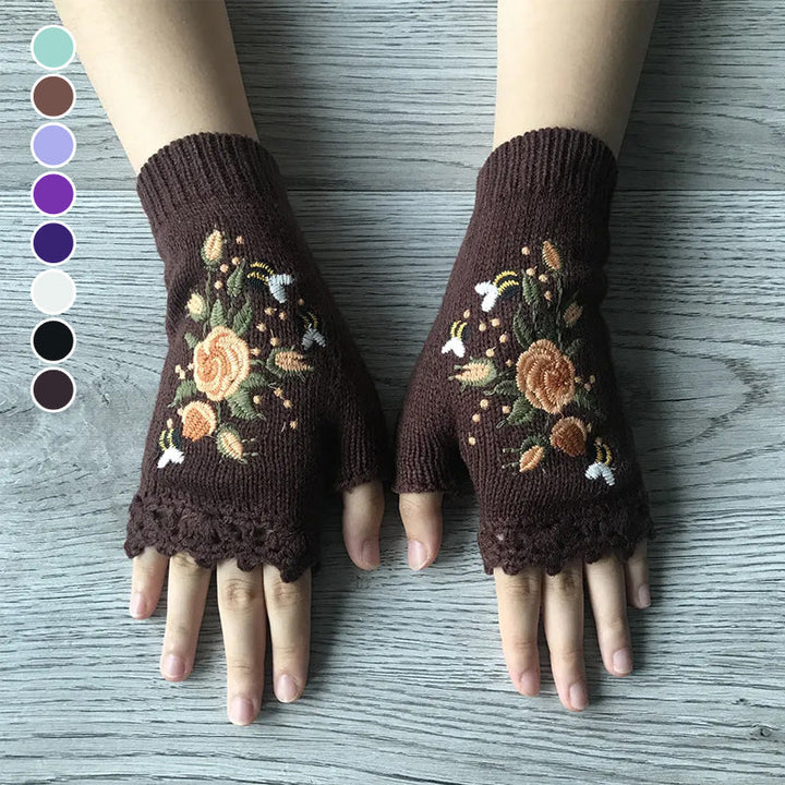 Close-up of women's black embroidered winter glove, intricate multi-color floral stitching, soft acrylic fabric.