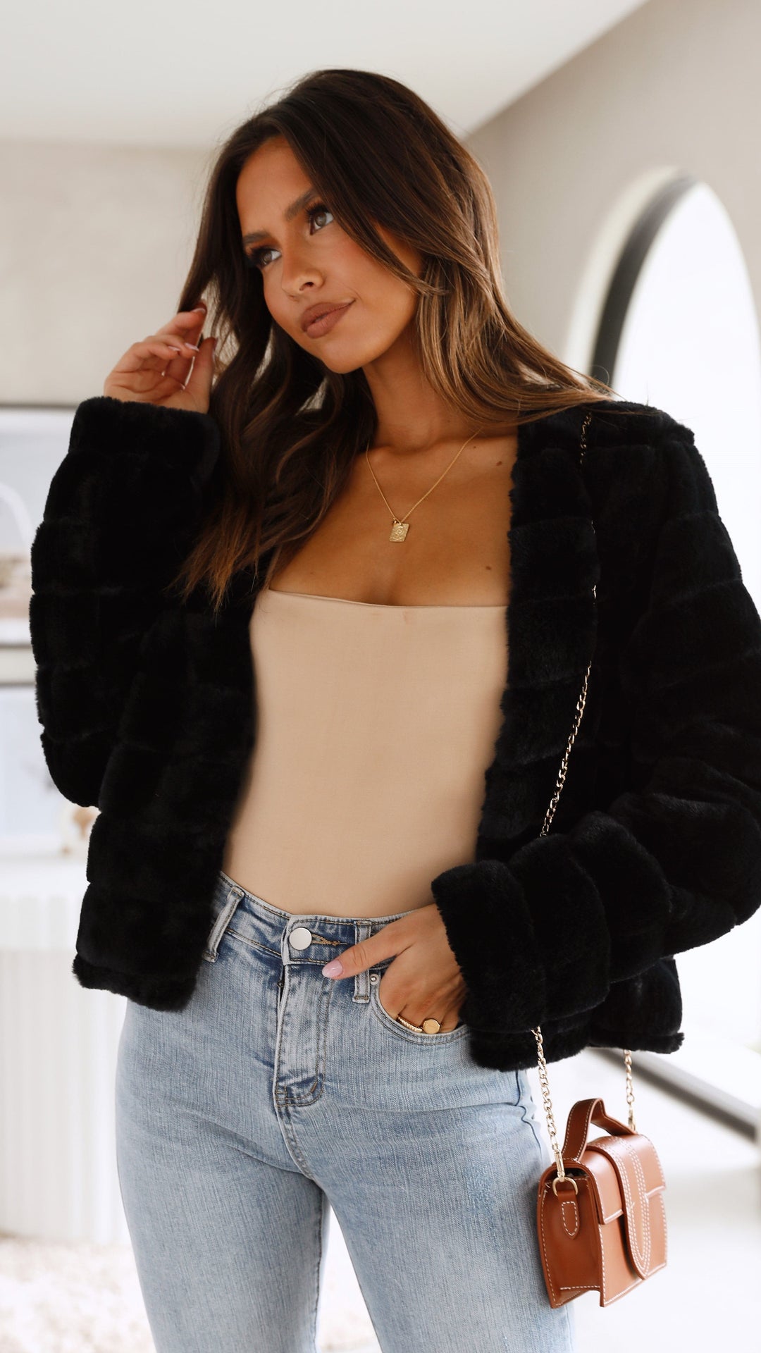 Women's faux fur jacket, cropped length, designed for chic evening occasions.