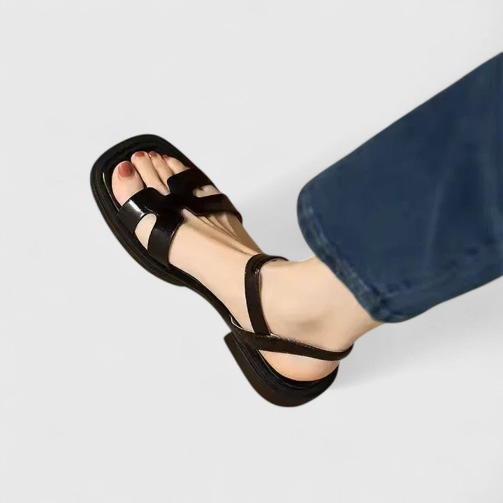 Comfortable women's flat sandals with a stylish cutout H-strap & secure ankle buckle for warm weather.