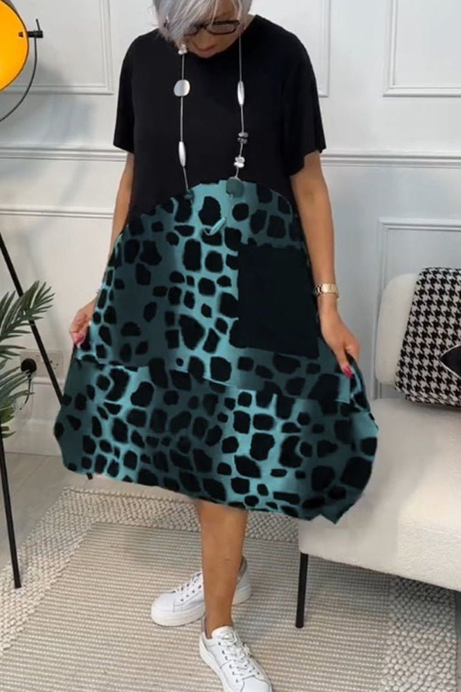 Women's sophisticated floral midi dress, perfect for spring, showcasing a flattering defined waist.