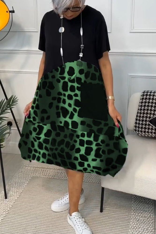 Chic women's floral midi dress with a flattering defined waist, perfect for elegant spring fashion.