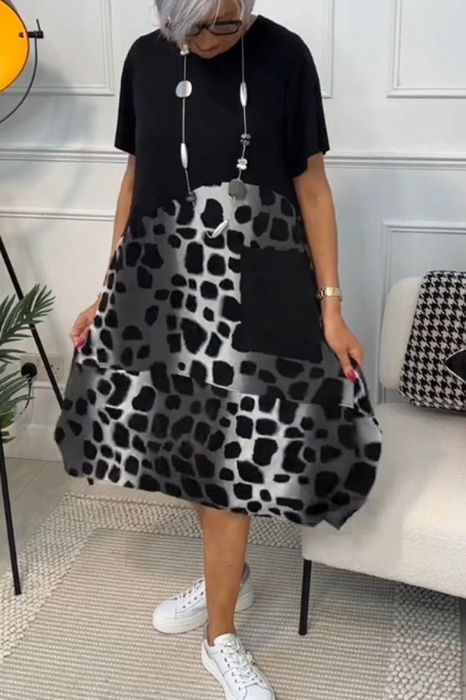 Women's spring fashion: an elegant floral midi dress with a flattering defined waist.