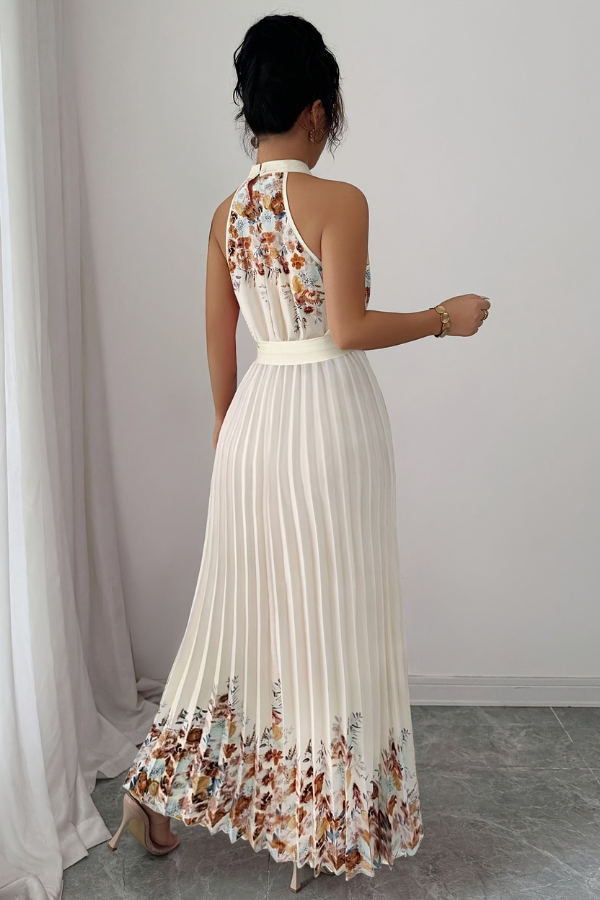 Model gracefully posing in an elegant floral pleated square neck midi dress. Perfect party attire.