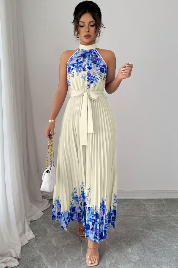 Movement shot: woman walking in a flowy floral pleated square neck midi dress. Ideal for vacation.