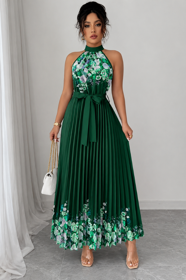 Woman sitting comfortably in an elegant floral pleated square neck midi dress. Casual yet chic.