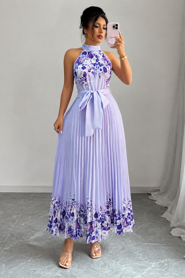 Full view of a model wearing a women's elegant floral pleated square neck midi dress outdoors.