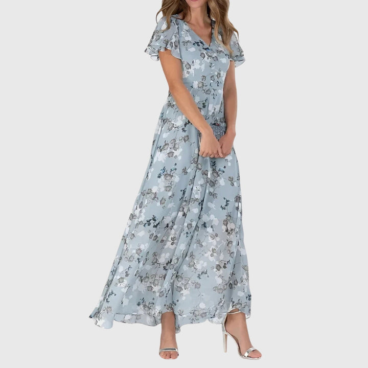 Comfortable A-line floral maxi dress for women, featuring flutter sleeves. Ideal as an elegant casual or summer evening dress.