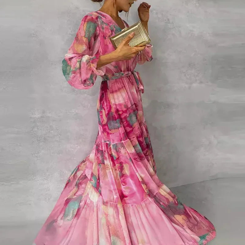 Flowy women's pink floral wrap maxi dress with V-neck and long sleeves, a chic and comfortable summer outfit.