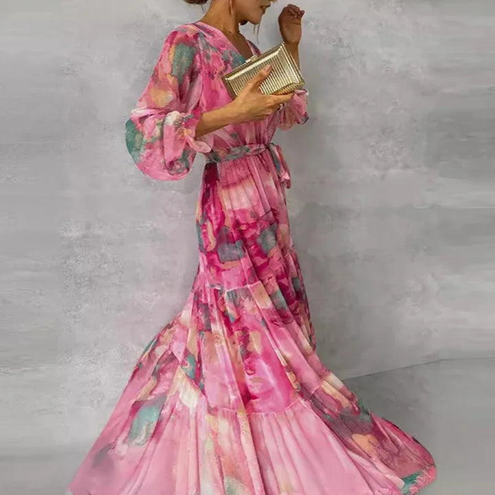 Flowy women's pink floral wrap maxi dress with V-neck and long sleeves, a chic and comfortable summer outfit.