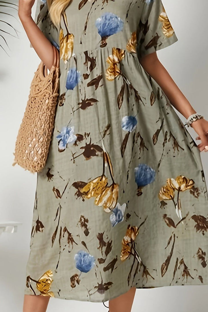Chic women's elegant midi dress featuring a vibrant floral print, a flattering choice for any summer gathering.