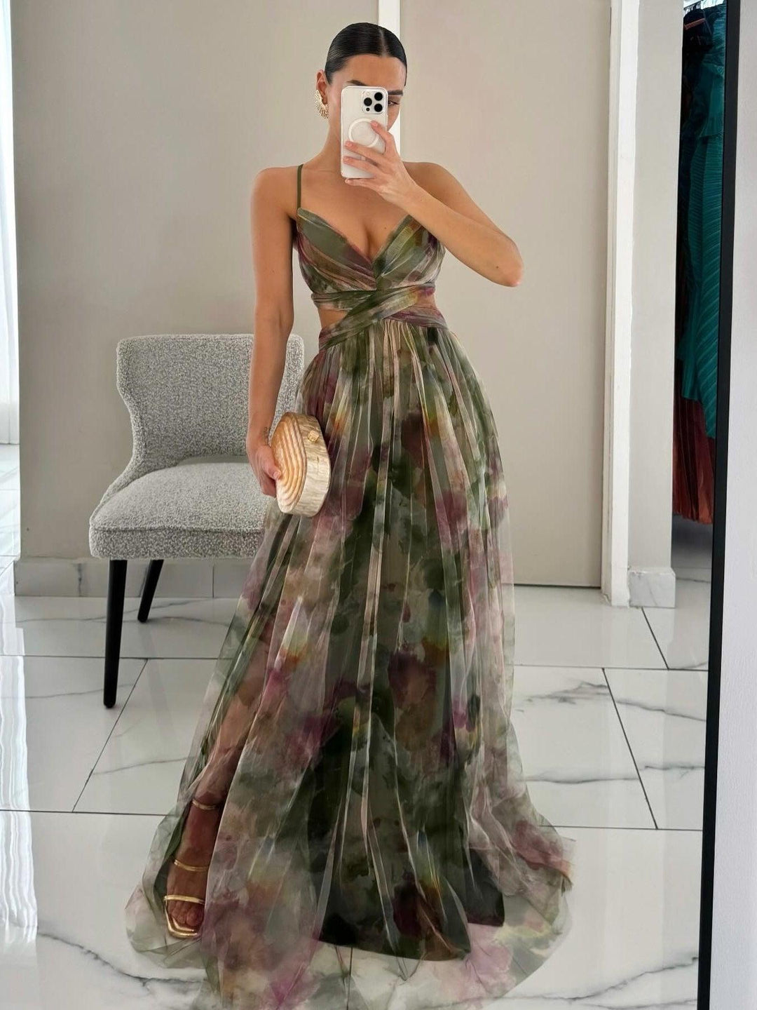 Women's elegant floral sleeveless V-neck maxi dress with a flattering tie waist, perfect for summer parties.