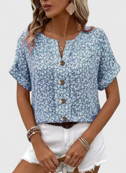 Breezy pink floral summer top for women, elegant and stylish short-sleeve design. Ideal for warm weather casual wear.
