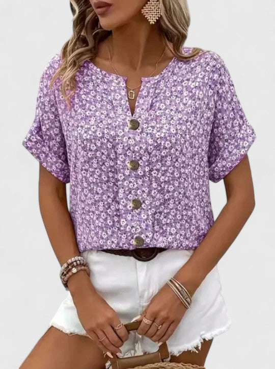 Women's vintage-style blue floral summer top. Elegant short-sleeve design, perfect for a chic and breezy look.
