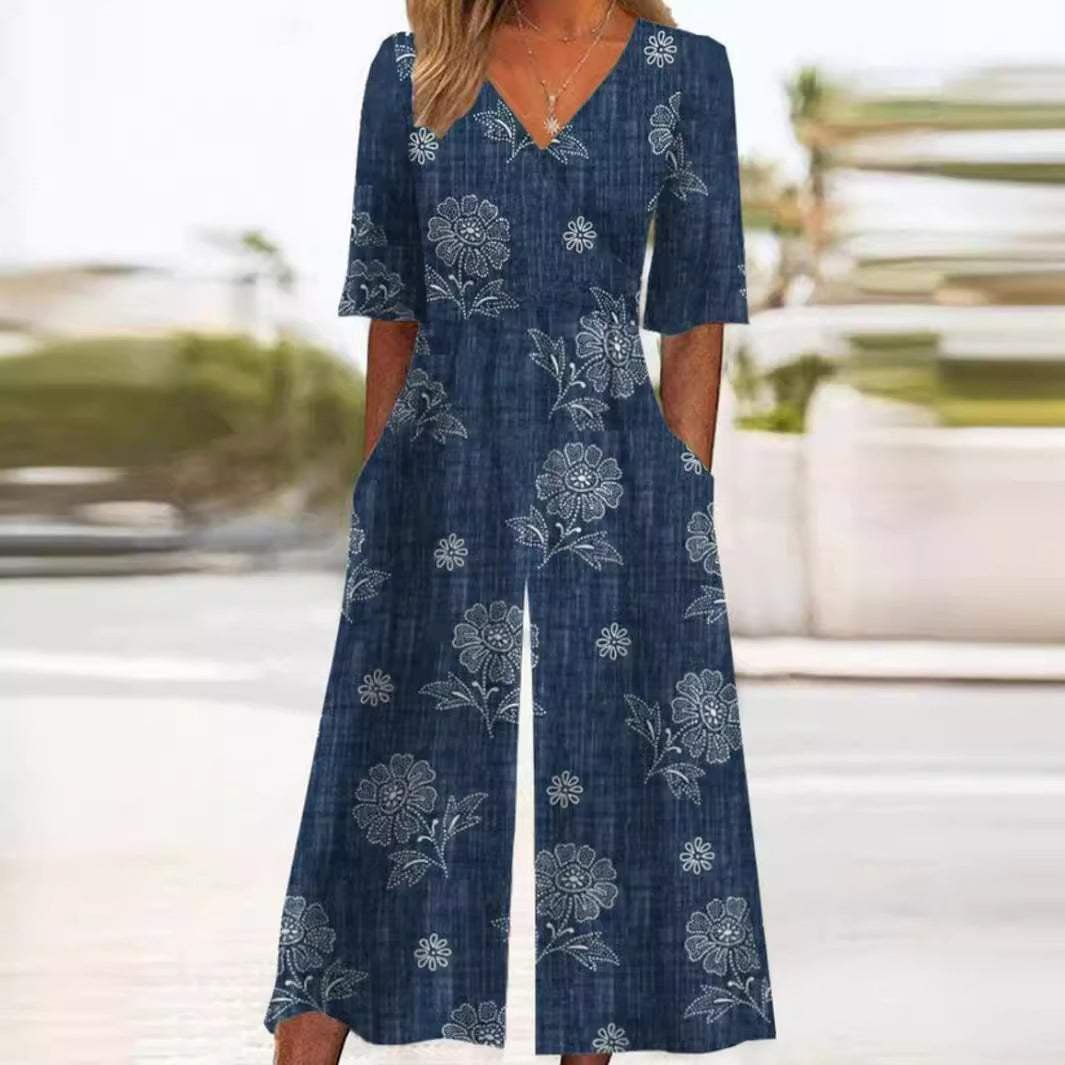 Chic women's V-neck floral wide-leg jumpsuit, bohemian style with elbow sleeves, perfect for elegant summer fashion.