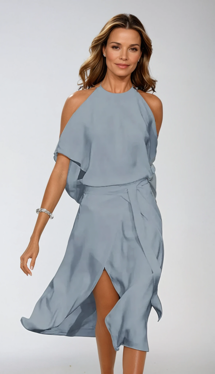 Glamorous flowy A-line halter evening dress for women, featuring an elegant slit. Ideal for summer parties.
