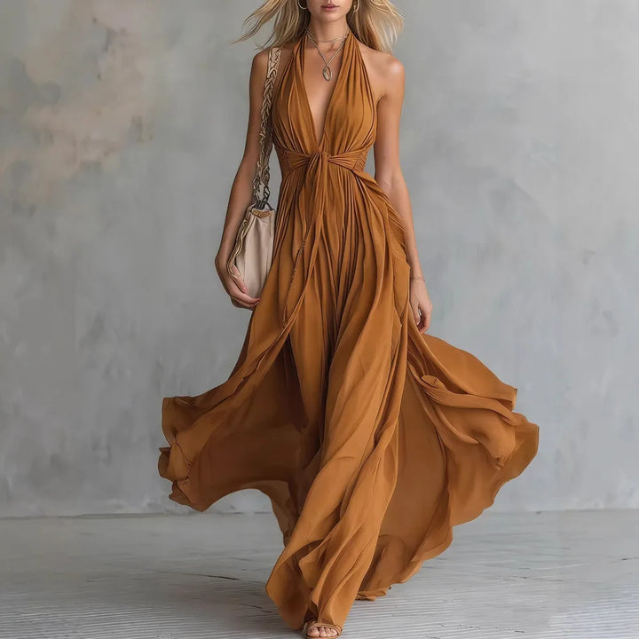 Gorgeous women's evening maxi dress featuring a flowy design and chic halter neckline, ideal for parties.