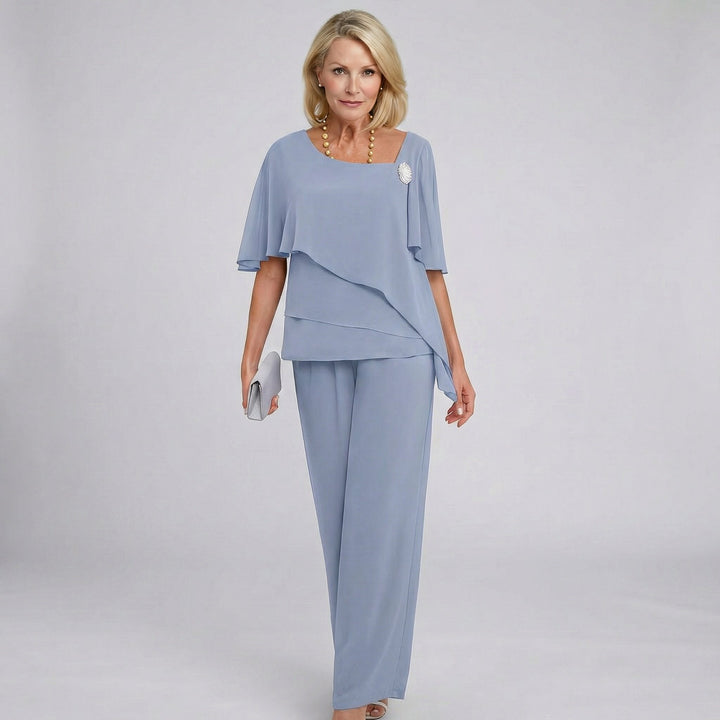 Elegant women's flutter sleeve wide-leg pant set, perfect formal attire for wedding guests & special occasions. Two-piece draped.