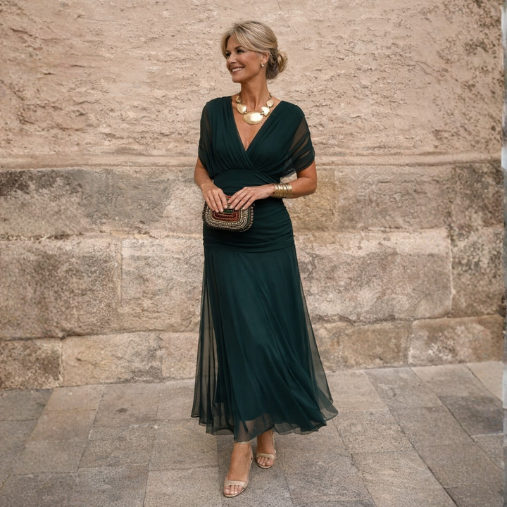 Elegant women's gathered V-neck midi dress with flutter sleeves, perfect for special occasions.