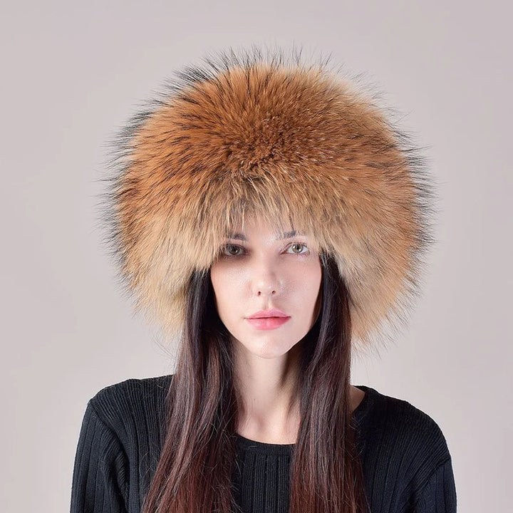 Women's genuine fox fur hat paired with a winter coat, demonstrating an elegant cold-weather look