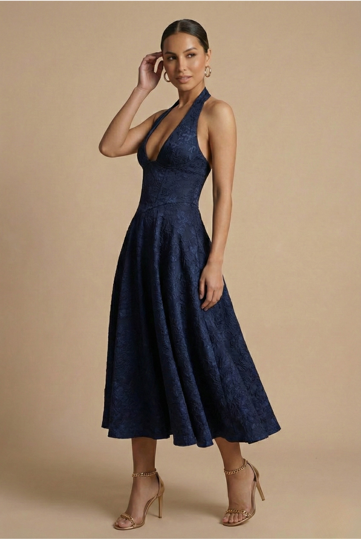 Woman models an elegant halter corset A-line midi dress, perfect for formal events & parties.