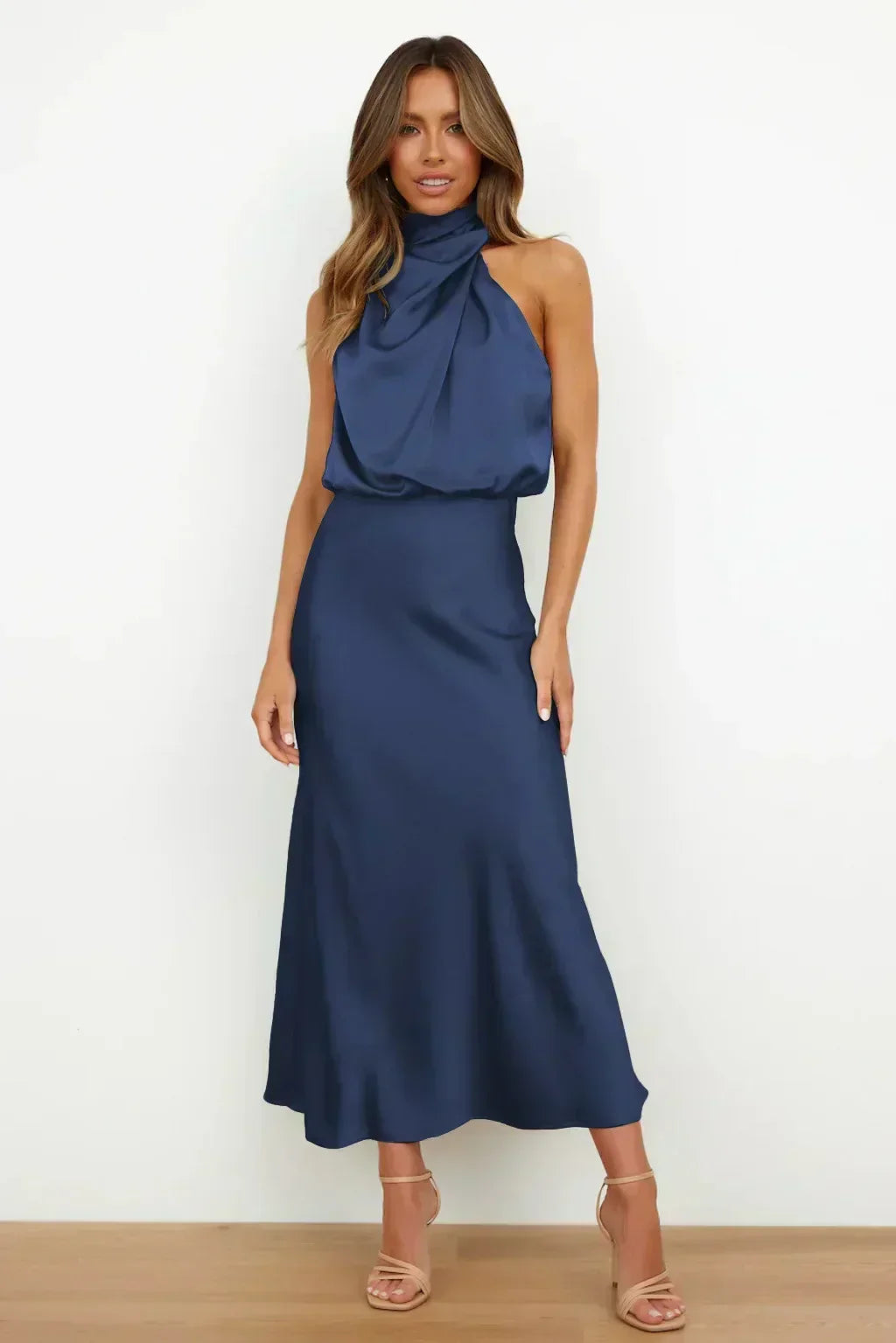 Back view of an alluring open back halter evening gown, long & sophisticated, ideal for special occasions.