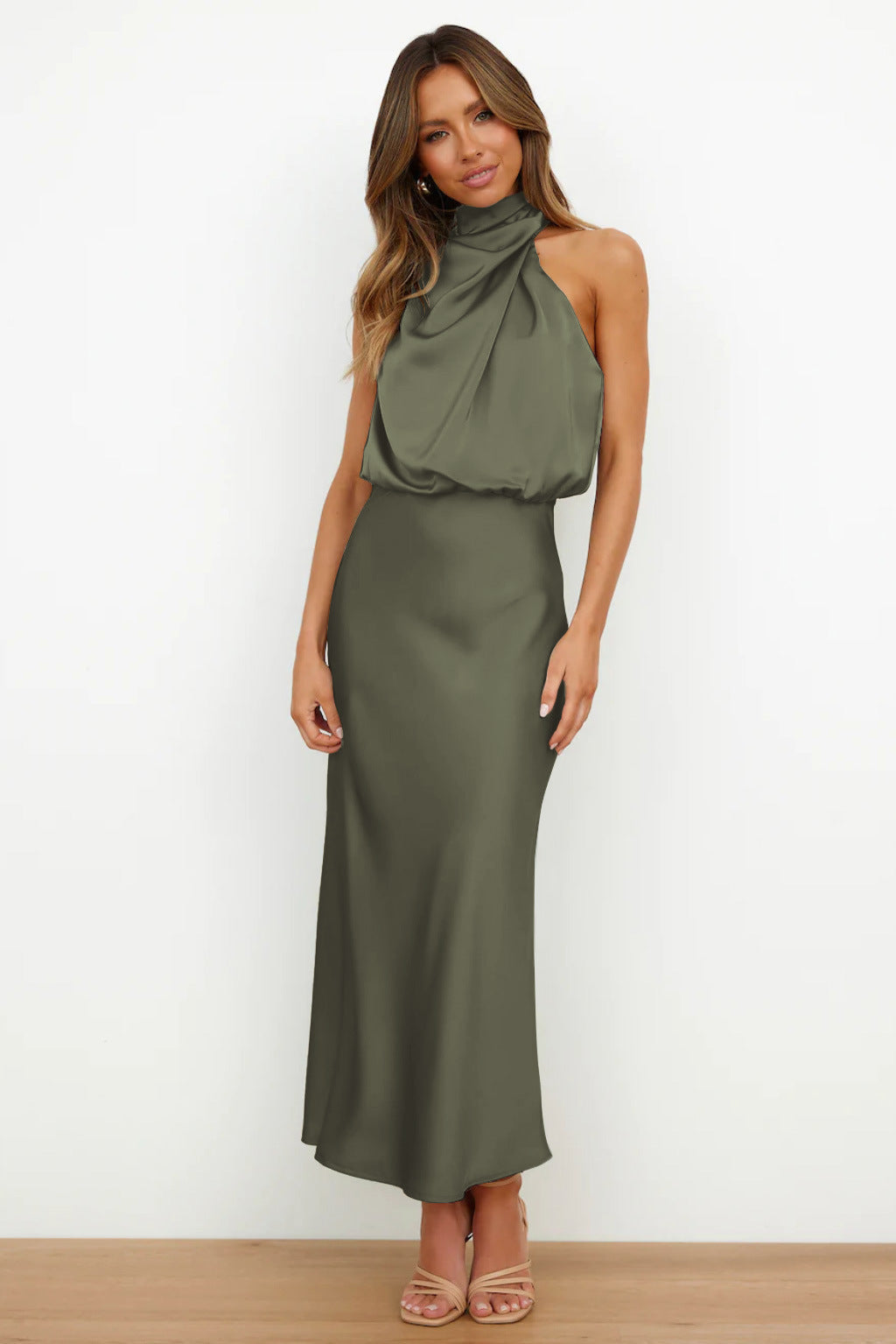Flowing elegant women's halter evening gown, floor-length with a graceful open back, for special events.