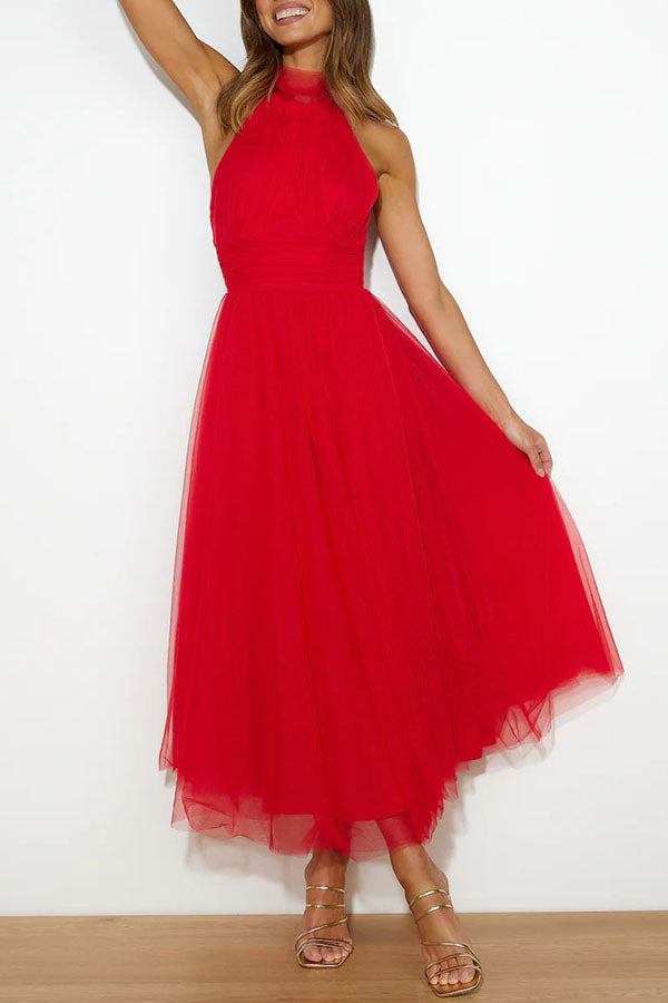 Close-up of the elegant bodice & halter neck of a women's maxi wedding guest dress. Formal sleeveless evening gown.