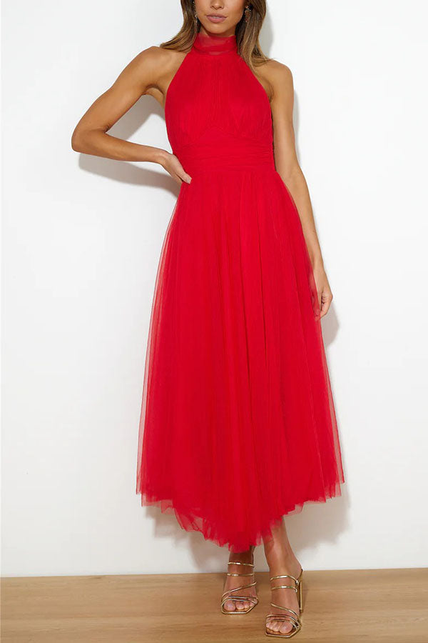 Back view of an elegant women's halter maxi evening gown. Flowy formal dress for special occasions & prom.