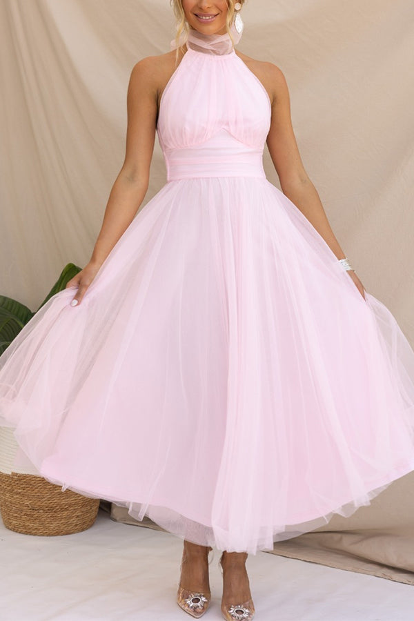 Side profile of a women's elegant halter maxi dress. Flowy silhouette, ideal wedding guest or formal evening gown.