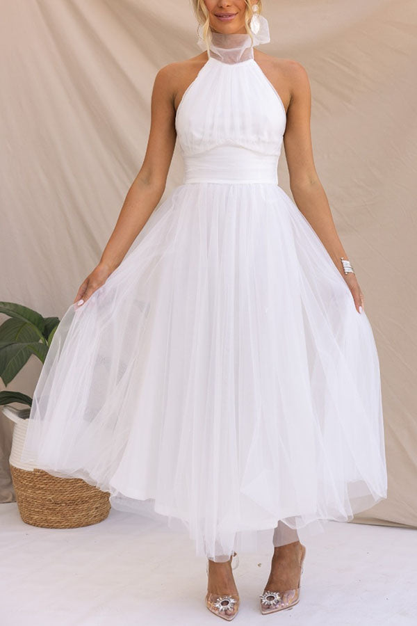 Stunning women's halter maxi wedding guest dress. Elegant flowy evening gown for any special formal occasion.
