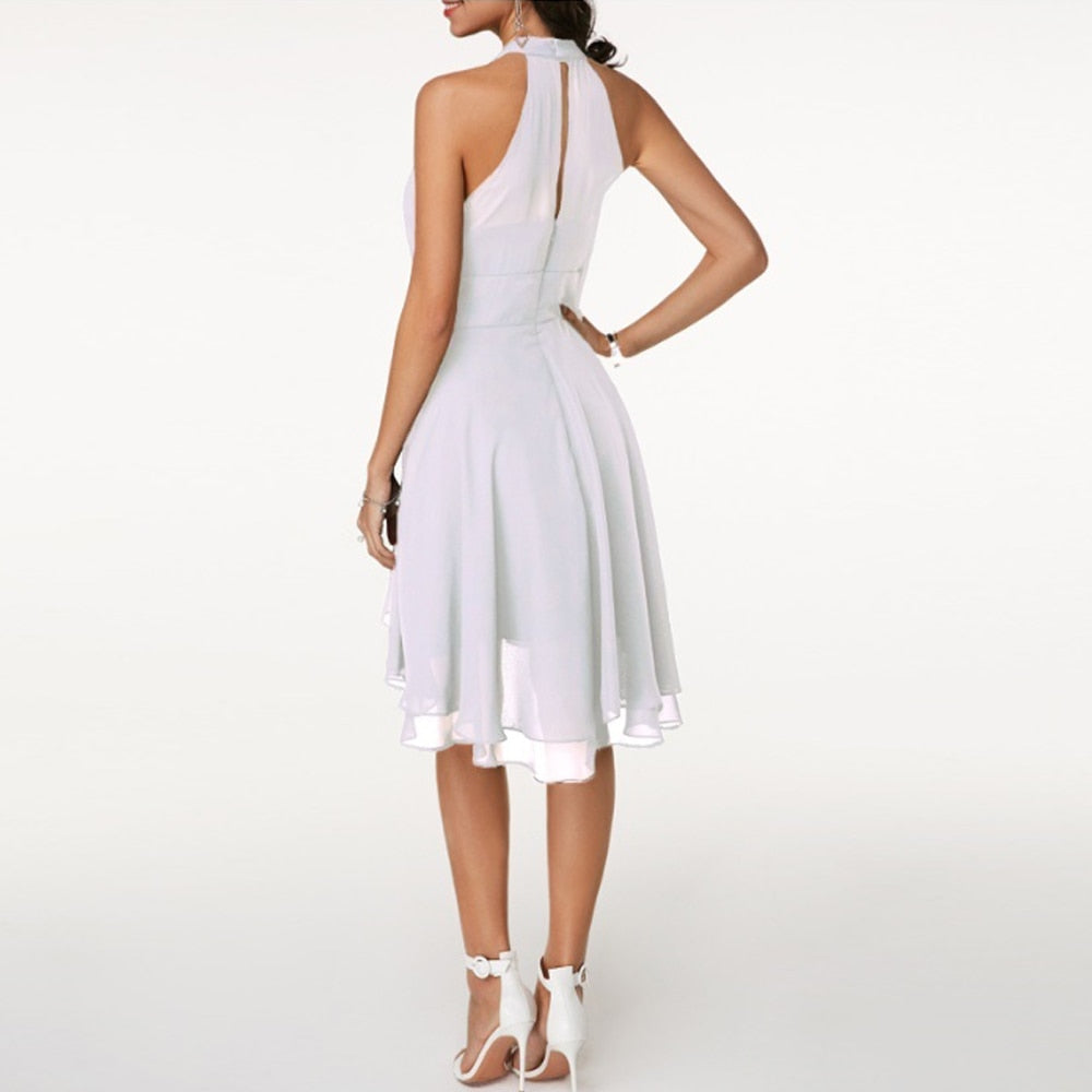 Chic women's sleeveless halter mini party dress with a flowing fluid drape, ideal for cocktail events.