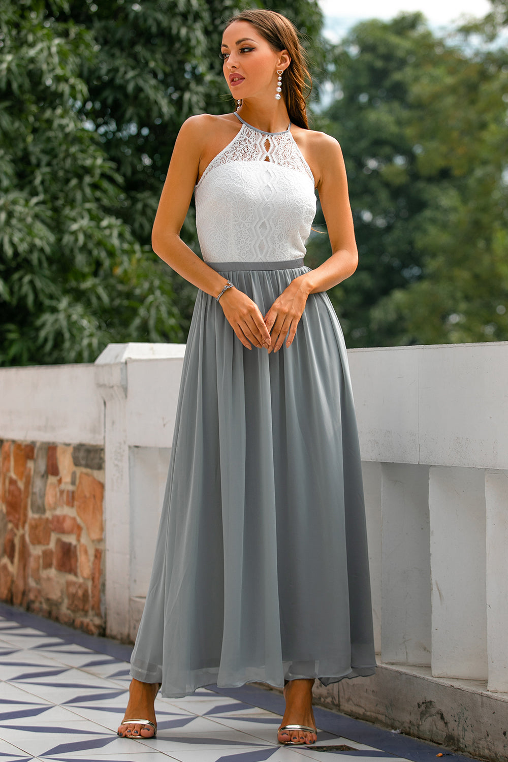 Luxurious flowing skirt details of a halter neck maxi dress, perfect for dancing at a wedding