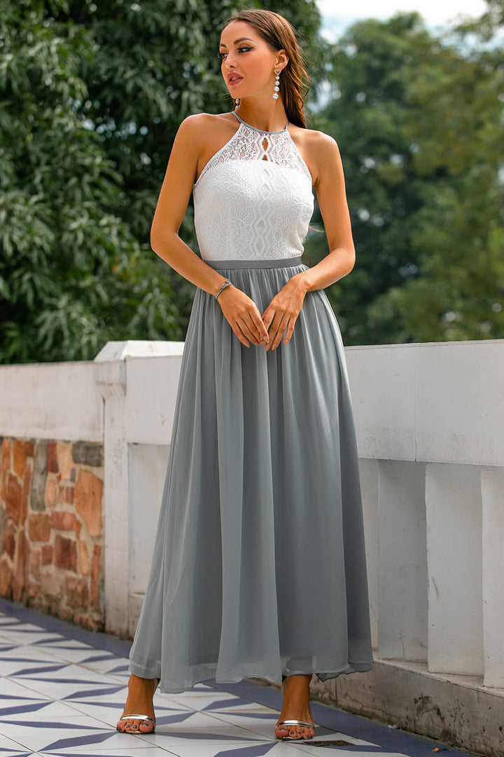 Luxurious flowing skirt details of a halter neck maxi dress, perfect for dancing at a wedding