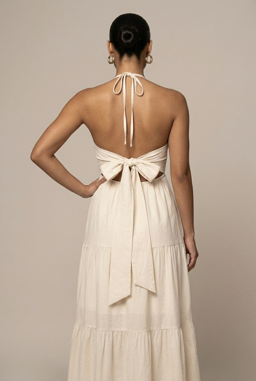 Flowy women's halter neck maxi dress with a chic open back and flattering tie waist, ideal for parties or beach.