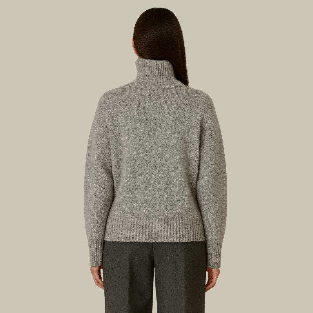 Cozy beige merino wool sweater with a high neck and relaxed fit for women, ideal knitwear.
