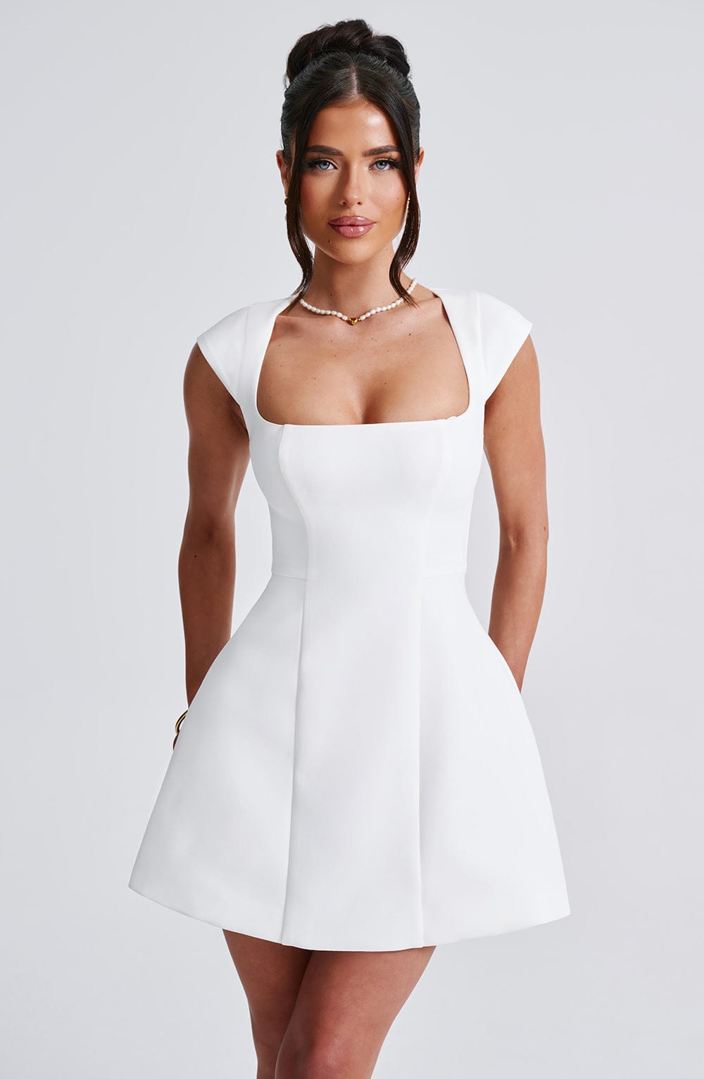Elegant women's ivory chic mini dress, perfect for cocktail parties & summer events. Flattering sleeveless design.