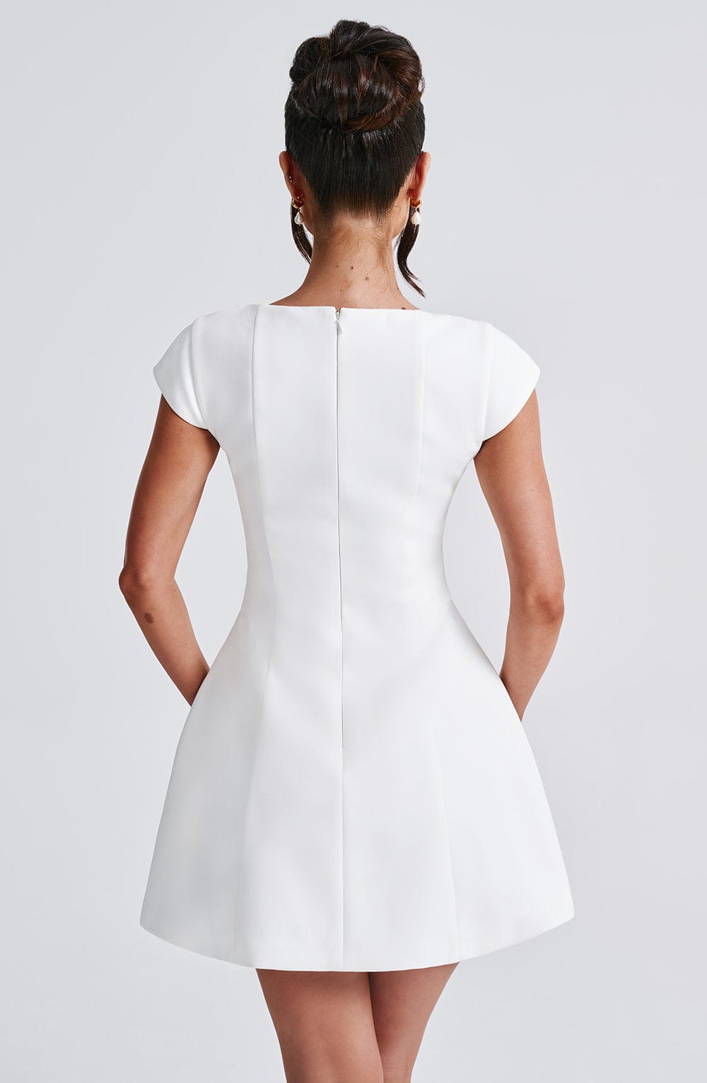 Chic women's tailored ivory mini dress with elegant silhouette. Versatile for modern party & summer fashion.