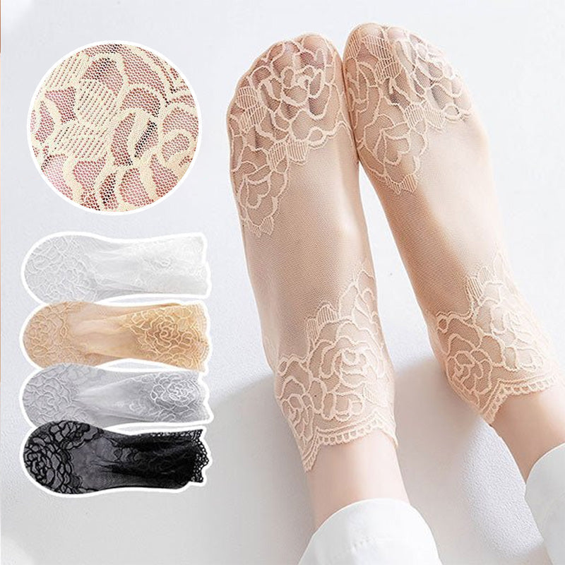 Pair of white elegant lace mesh ankle socks spread out, highlighting the intricate design.
