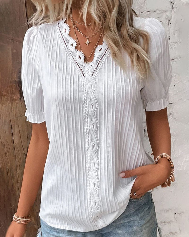 Stylish women's v-neck lace top with intricate floral details, ideal for evening parties or casual chic spring/summer wear.