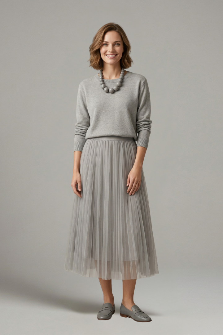 Women's long-sleeve layered dress featuring a round neck & flowing pleated midi skirt. Versatile fall/spring fashion.
